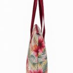 side view of tropical floral beach tote bag showing slim gusset zipper and burgundy handles