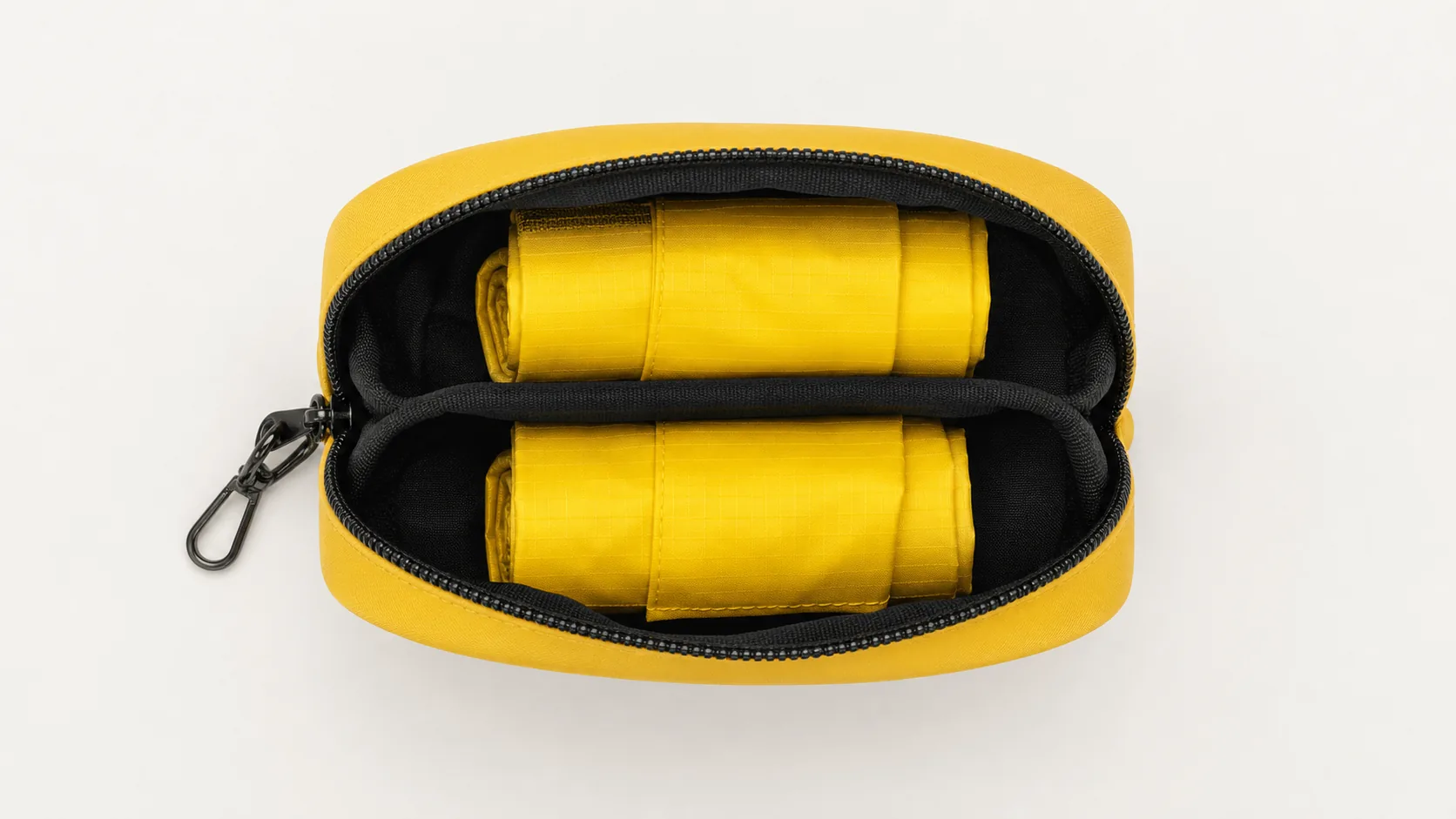 Open yellow dual-compartment pouch holding two folded reusable shopping bags