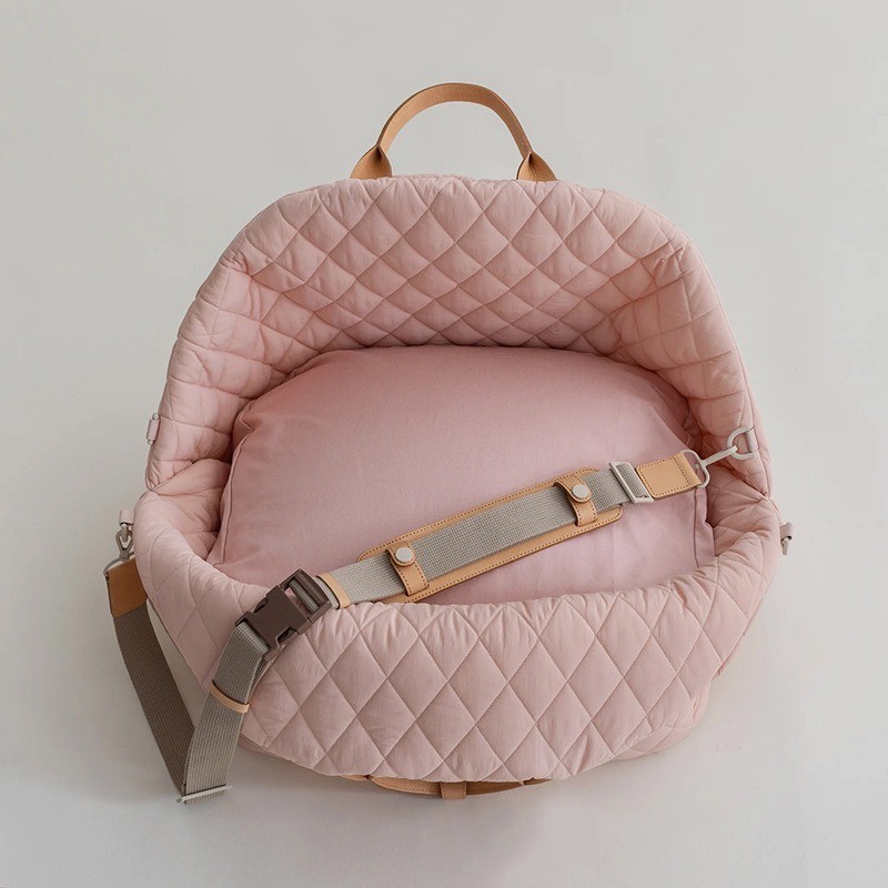 open quilted pet car seat carrier with a small dog